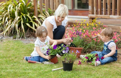 Seasonal garden care in Perivale with flowering plants and lawn improvement