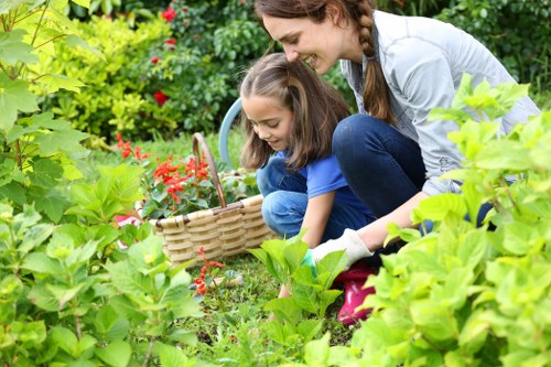 Gardeners working safely with tools and protective equipment